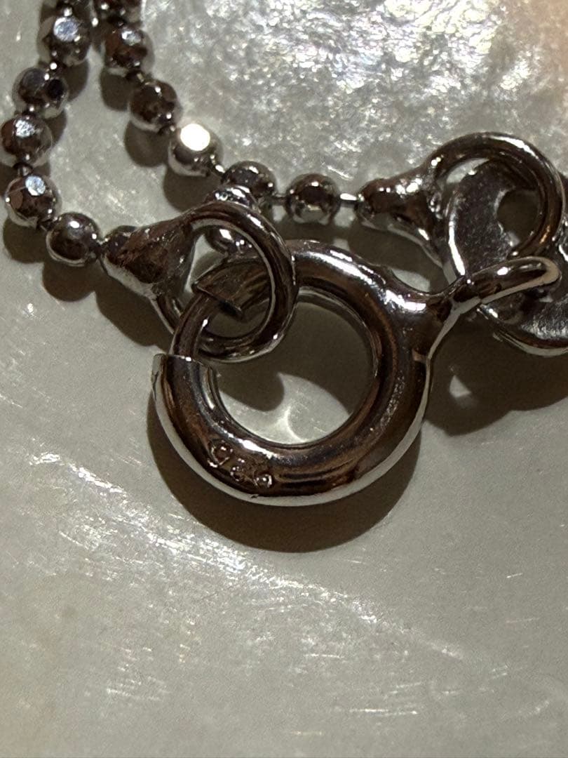 Tasaki silver necklace with a pearl pendant and lobster clasp displayed with a dedicated case