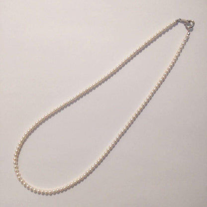 Close-up of Baby Akoya Pearl Necklace with 3-3.5mm pearls, 43cm length, displayed on a white background