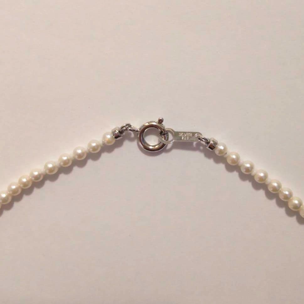 Close-up of Baby Akoya Pearl Necklace with 3-3.5mm pearls, 43cm length, displayed on a white background