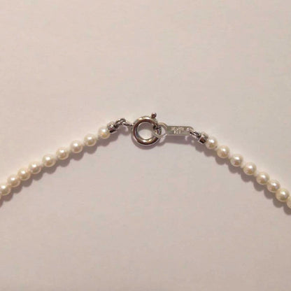 Close-up of Baby Akoya Pearl Necklace with 3-3.5mm pearls, 43cm length, displayed on a white background