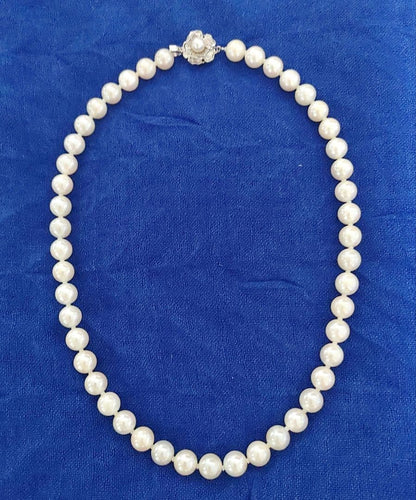Akoya pearl necklace featuring 8-8.5mm pearls and a charm on a 45cm chain displayed on white background