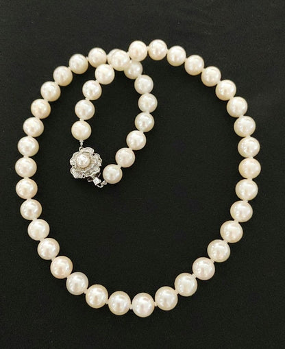 Akoya pearl necklace featuring 8-8.5mm pearls and a charm on a 45cm chain displayed on white background