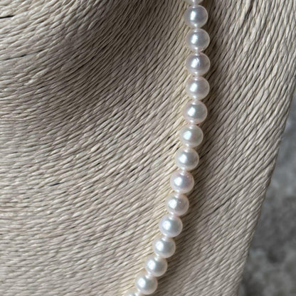 Akoya pearl necklace featuring 7mm white round beads on a 42cm silver-stamped string