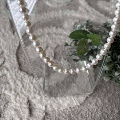 Akoya pearl necklace featuring 7mm white round beads on a 42cm silver-stamped string