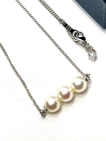 Plain Akoya pearl necklace with three 7mm round pearls on a 66cm silver chain featuring natural pink green tones