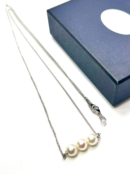 Plain Akoya pearl necklace with three 7mm round pearls on a 66cm silver chain featuring natural pink green tones