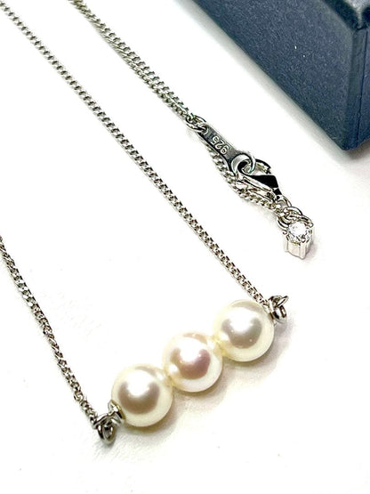 Plain Akoya pearl necklace with three 7mm round pearls on a 66cm silver chain featuring natural pink green tones