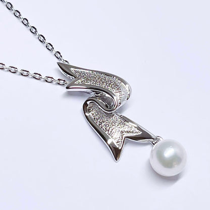 Mikimoto pearl necklace featuring 6.6mm pearls with a silver ribbon pendant on a 41cm chain