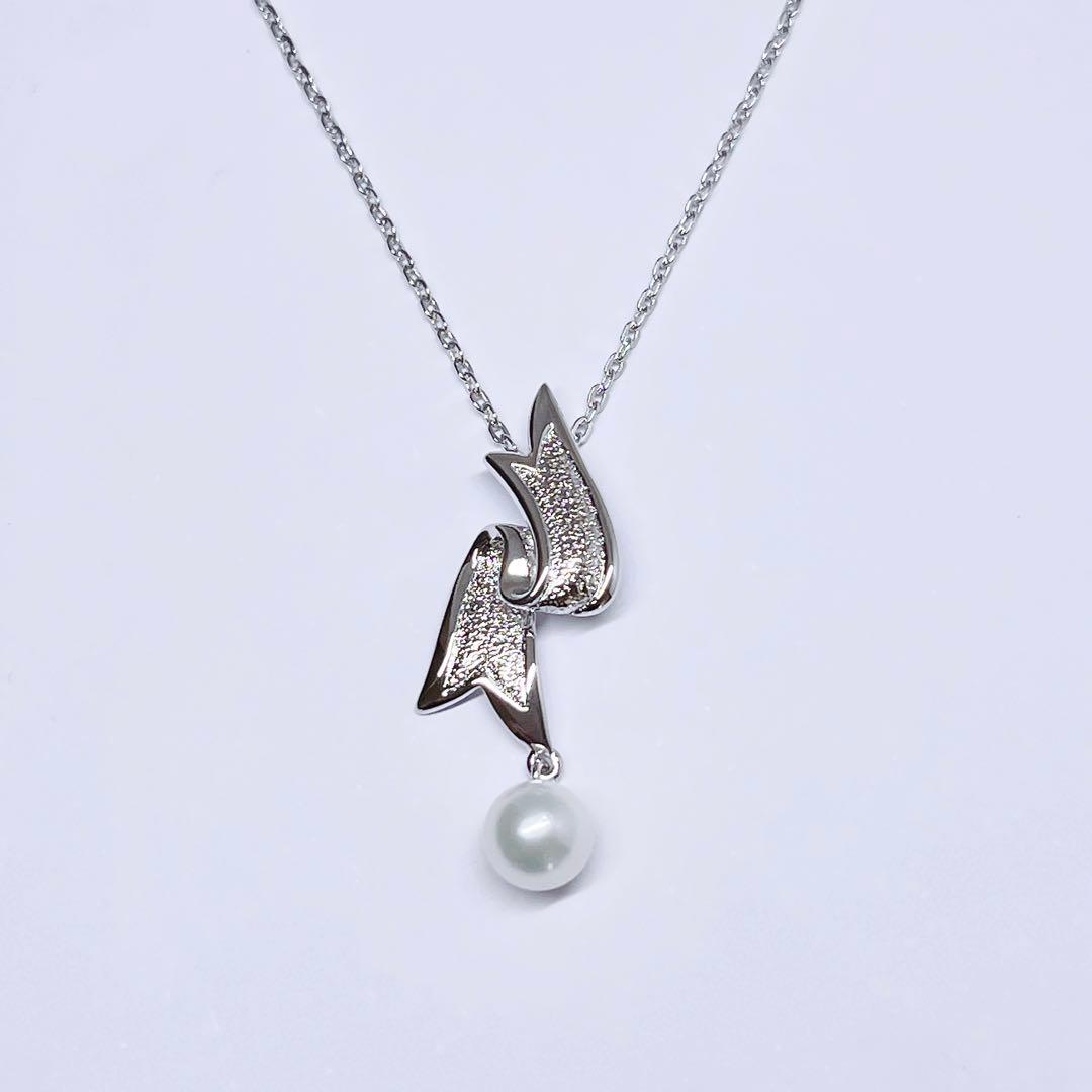 Mikimoto pearl necklace featuring 6.6mm pearls with a silver ribbon pendant on a 41cm chain