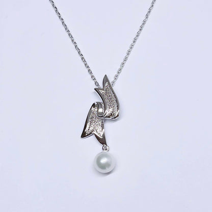 Mikimoto pearl necklace featuring 6.6mm pearls with a silver ribbon pendant on a 41cm chain