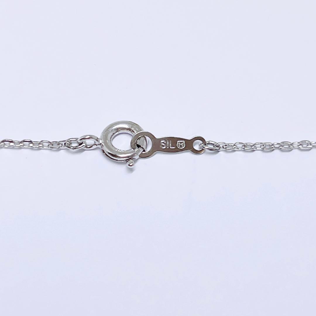 Mikimoto pearl necklace featuring 6.6mm pearls with a silver ribbon pendant on a 41cm chain