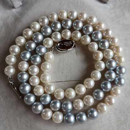 Akoya Pearl Semi-Long Necklace 87 featuring white and light gray pearls with silver clasp on a white background