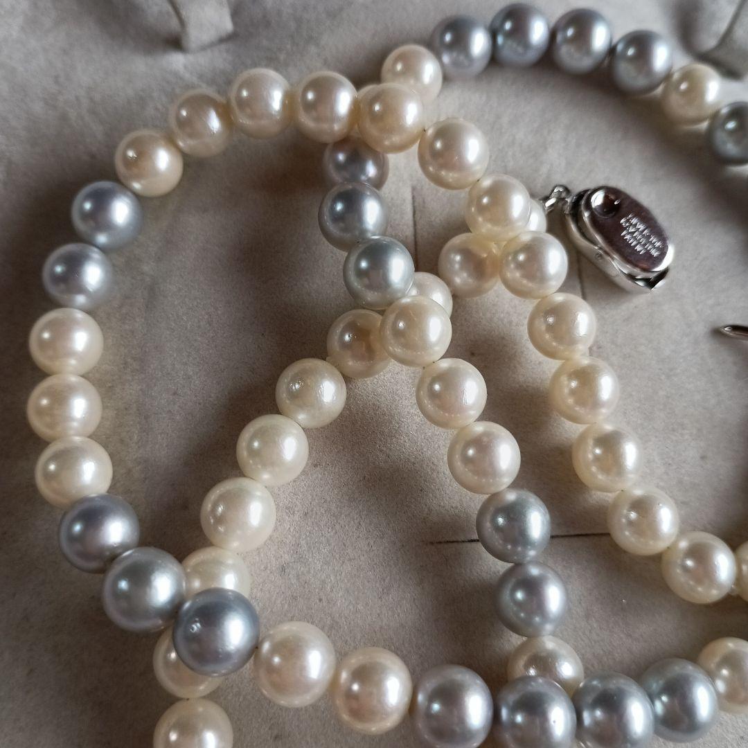 Akoya Pearl Semi-Long Necklace 87 featuring white and light gray pearls with silver clasp on a white background