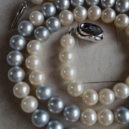 Akoya Pearl Semi-Long Necklace 87 featuring white and light gray pearls with silver clasp on a white background