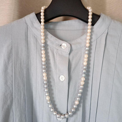 Akoya Pearl Semi-Long Necklace 87 featuring white and light gray pearls with silver clasp on a white background