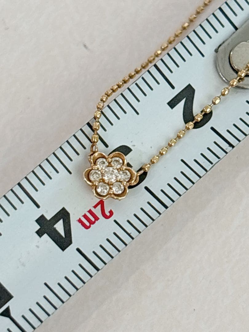 Agete flower motif necklace with 0.08ct diamond and adjustable 40.5 cm chain on white background