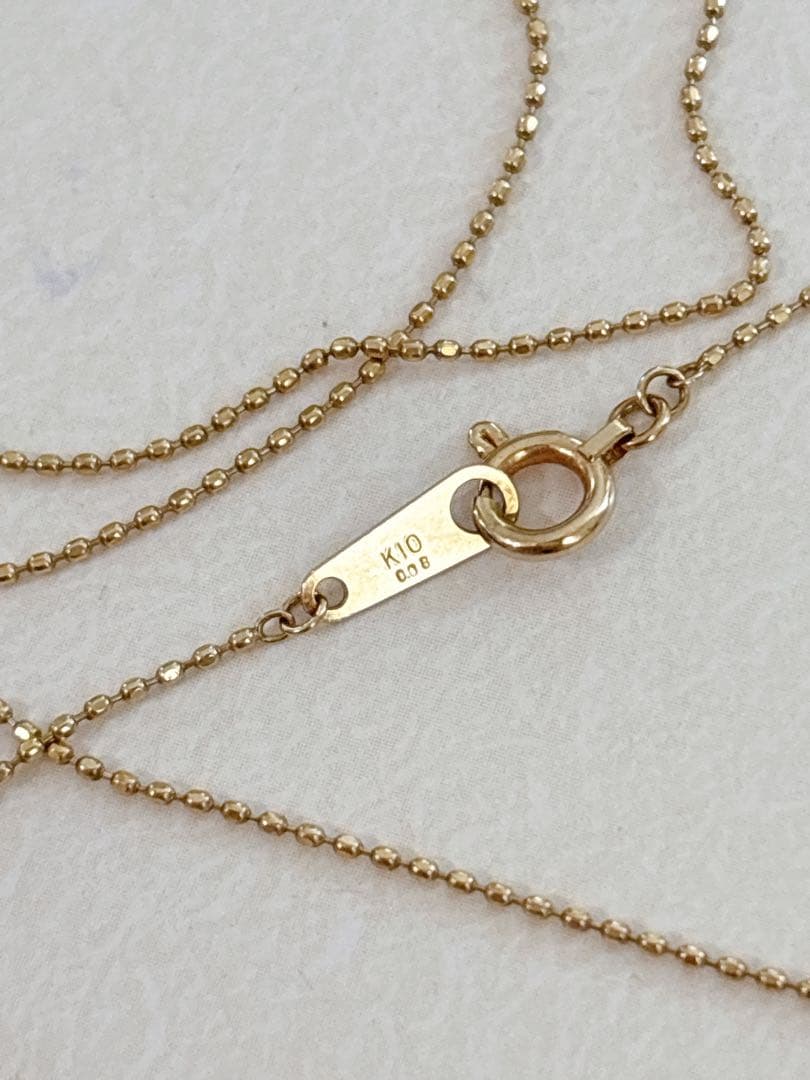 Agete flower motif necklace with 0.08ct diamond and adjustable 40.5 cm chain on white background