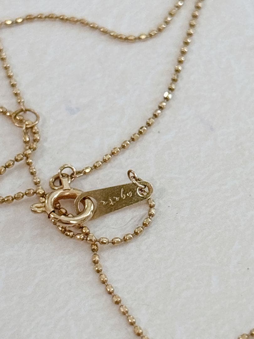 Agete flower motif necklace with 0.08ct diamond and adjustable 40.5 cm chain on white background