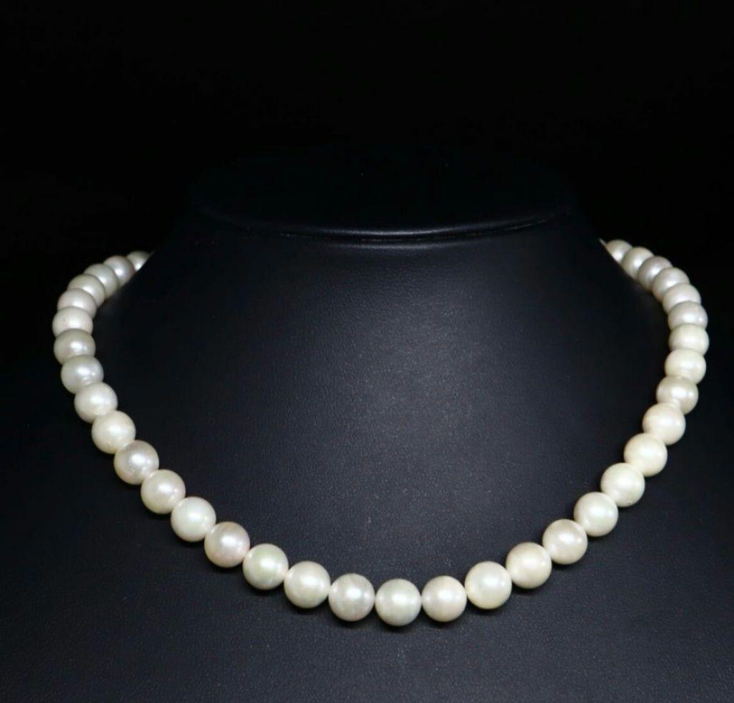 Akoya pearl necklace and matching earrings with 8.5mm round natural white pearls and silver clasp