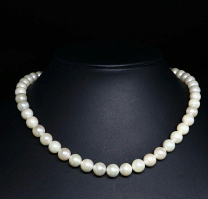 Akoya pearl necklace and matching earrings with 8.5mm round natural white pearls and silver clasp