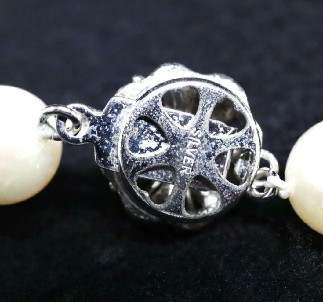 Akoya pearl necklace and matching earrings with 8.5mm round natural white pearls and silver clasp