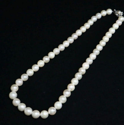Akoya pearl necklace and matching earrings with 8.5mm round natural white pearls and silver clasp