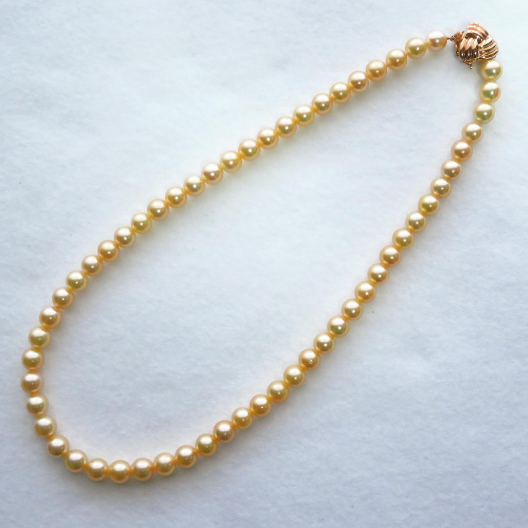 Akoya Pearl Necklace with K14 clasp, 44cm length, showcasing lustrous round pearls and certification tag
