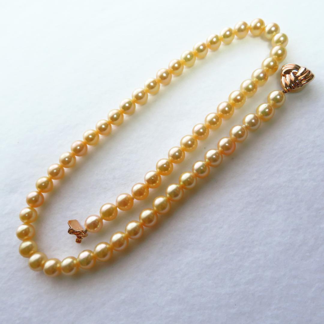 Akoya Pearl Necklace with K14 clasp, 44cm length, showcasing lustrous round pearls and certification tag