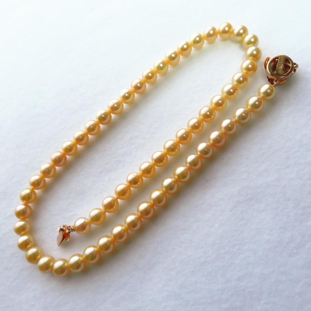 Akoya Pearl Necklace with K14 clasp, 44cm length, showcasing lustrous round pearls and certification tag