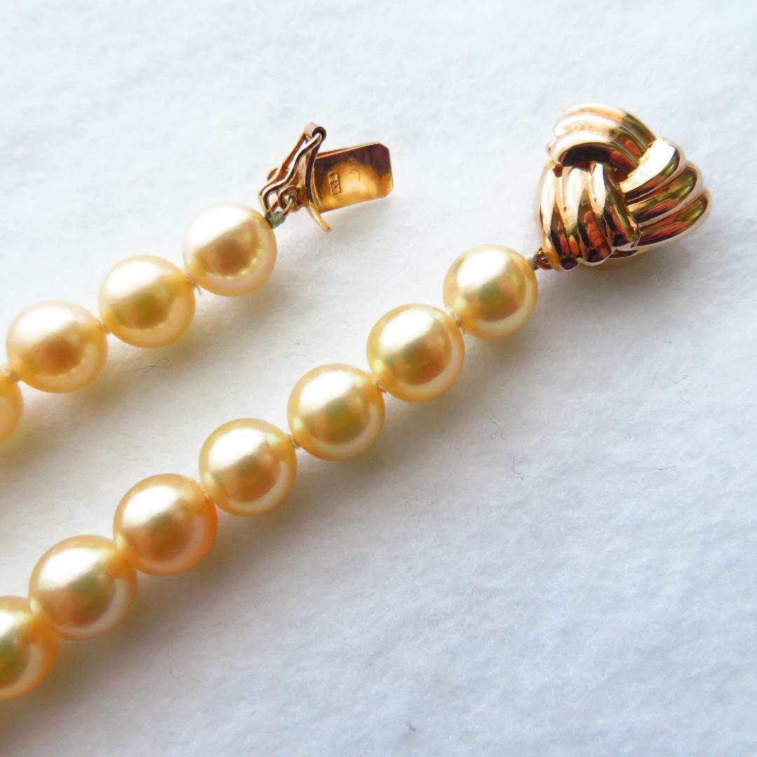 Akoya Pearl Necklace with K14 clasp, 44cm length, showcasing lustrous round pearls and certification tag