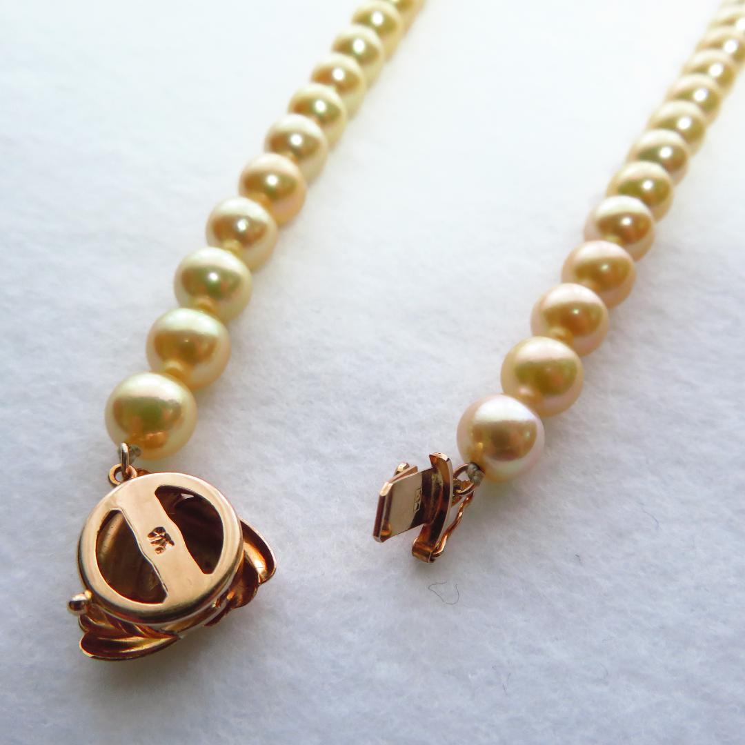 Akoya Pearl Necklace with K14 clasp, 44cm length, showcasing lustrous round pearls and certification tag