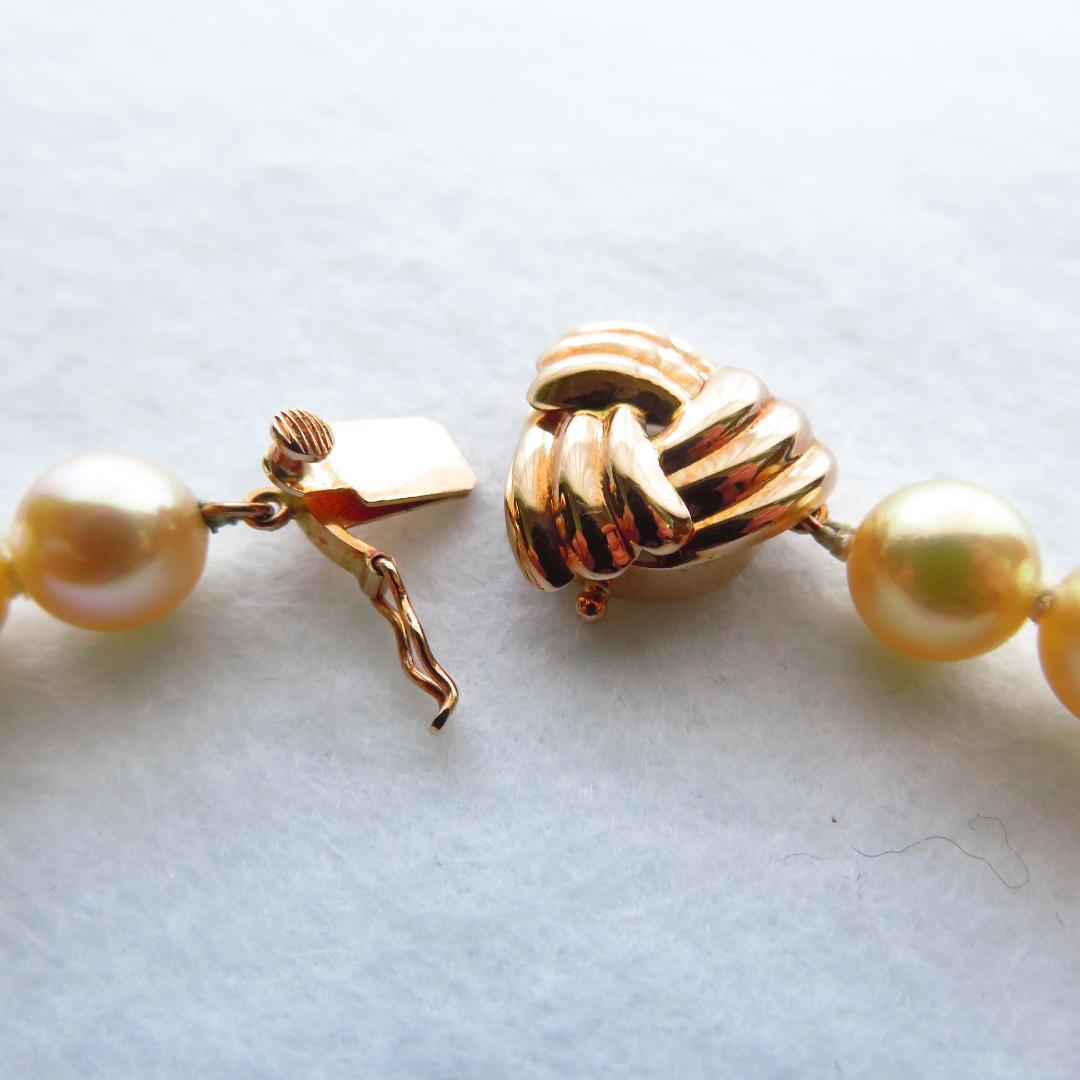 Akoya Pearl Necklace with K14 clasp, 44cm length, showcasing lustrous round pearls and certification tag