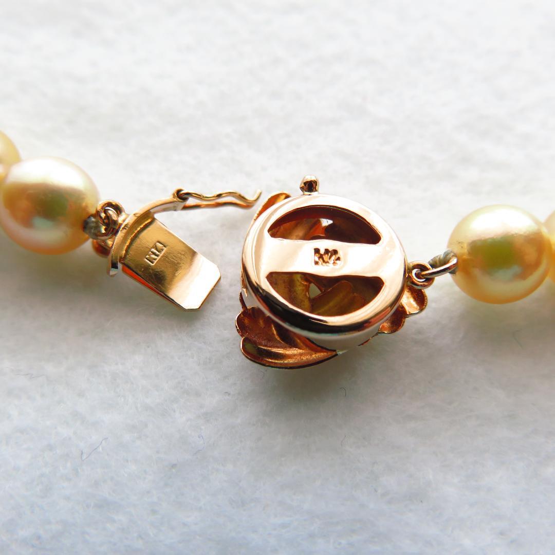 Akoya Pearl Necklace with K14 clasp, 44cm length, showcasing lustrous round pearls and certification tag