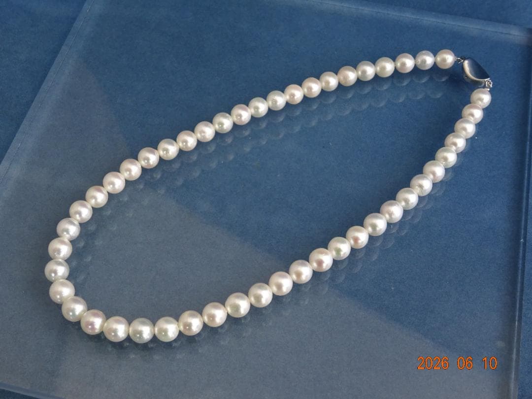 Akoya pearl necklace featuring 8-8.5mm almost round white pearls with pink and cream tones and silver clasp