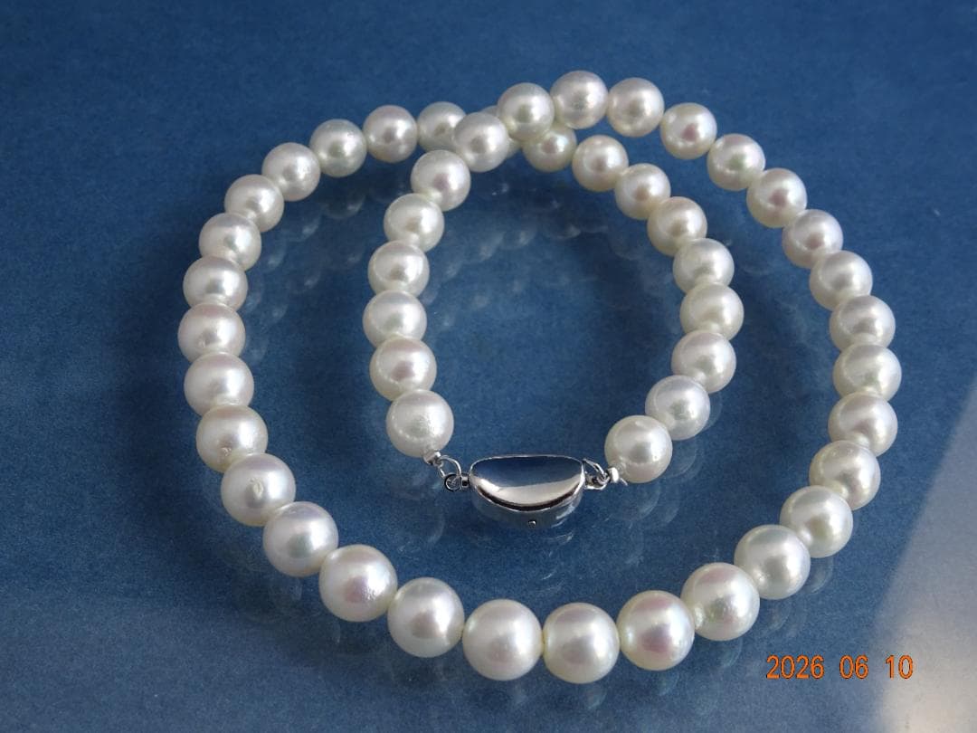 Akoya pearl necklace featuring 8-8.5mm almost round white pearls with pink and cream tones and silver clasp
