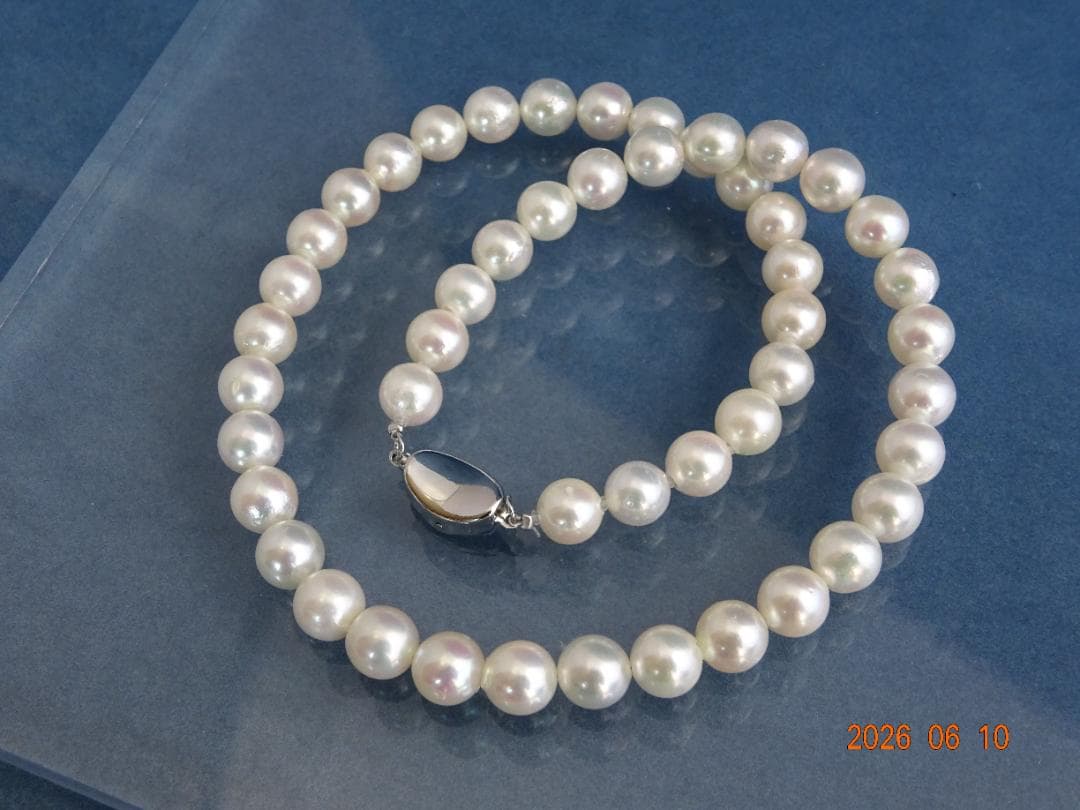 Akoya pearl necklace featuring 8-8.5mm almost round white pearls with pink and cream tones and silver clasp