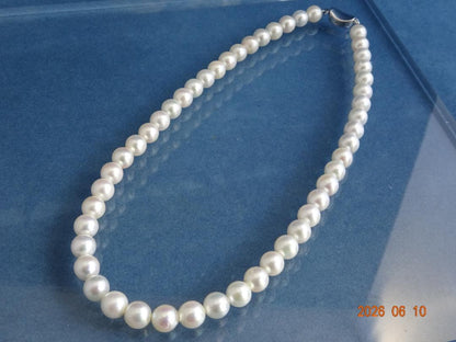 Akoya pearl necklace featuring 8-8.5mm almost round white pearls with pink and cream tones and silver clasp