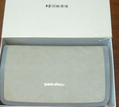 Tasaki Akoya Pearl 7.0mm necklace and matching 7.0mm pearl earrings on a white background
