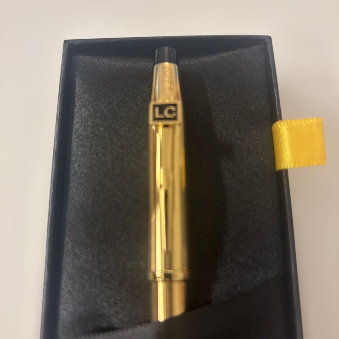 Luxury Card Cross gold ballpoint pen with LC logo on a white background