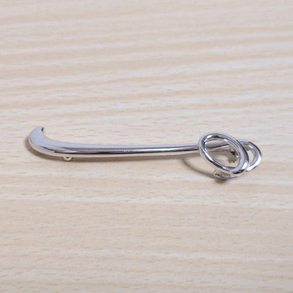 Tasaki silver necklace with 7.5mm pearl and matching brooch on white background