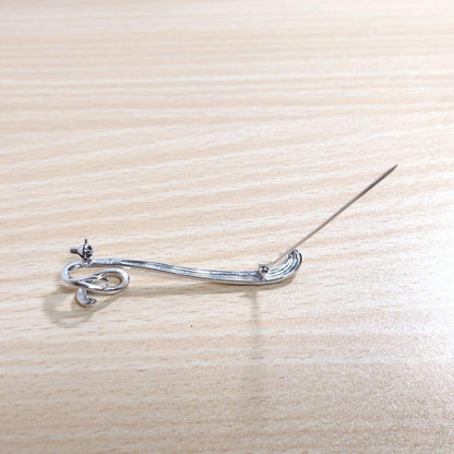 Tasaki silver necklace with 7.5mm pearl and matching brooch on white background