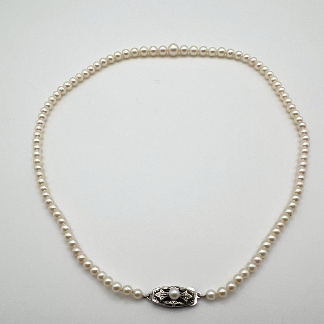 MIKIMOTO pearl necklace with white 7mm pearls and silver fittings, classic design, used condition