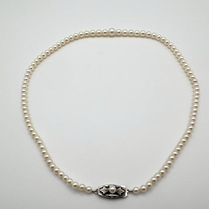 MIKIMOTO pearl necklace with white 7mm pearls and silver fittings, classic design, used condition
