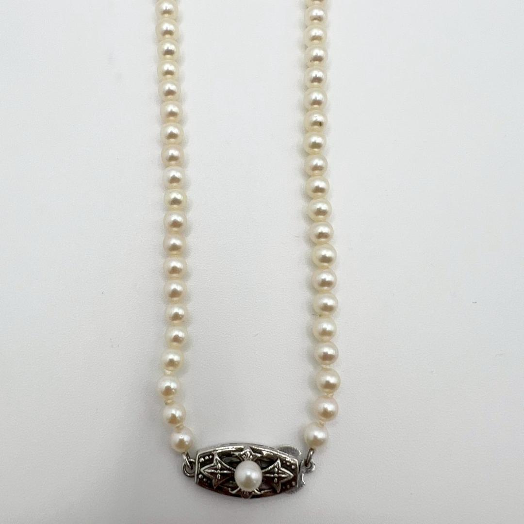 MIKIMOTO pearl necklace with white 7mm pearls and silver fittings, classic design, used condition