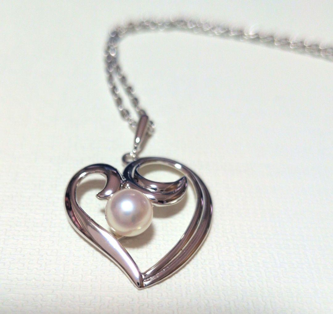 Mikimoto Pearl Heart Necklace featuring a silver heart pendant with a single pearl