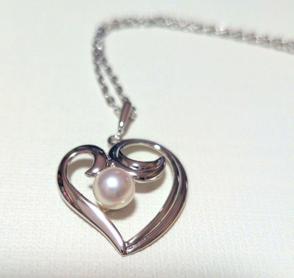 Mikimoto Pearl Heart Necklace featuring a silver heart pendant with a single pearl