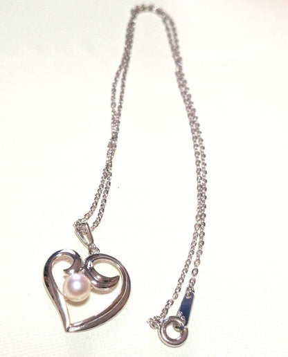 Mikimoto Pearl Heart Necklace featuring a silver heart pendant with a single pearl