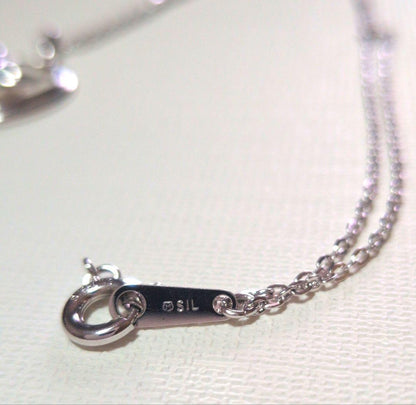 Mikimoto Pearl Heart Necklace featuring a silver heart pendant with a single pearl