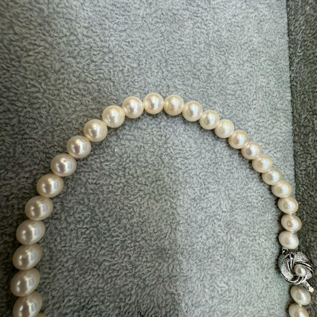 Short Akoya pearl necklace with 8mm white pearls on a white background