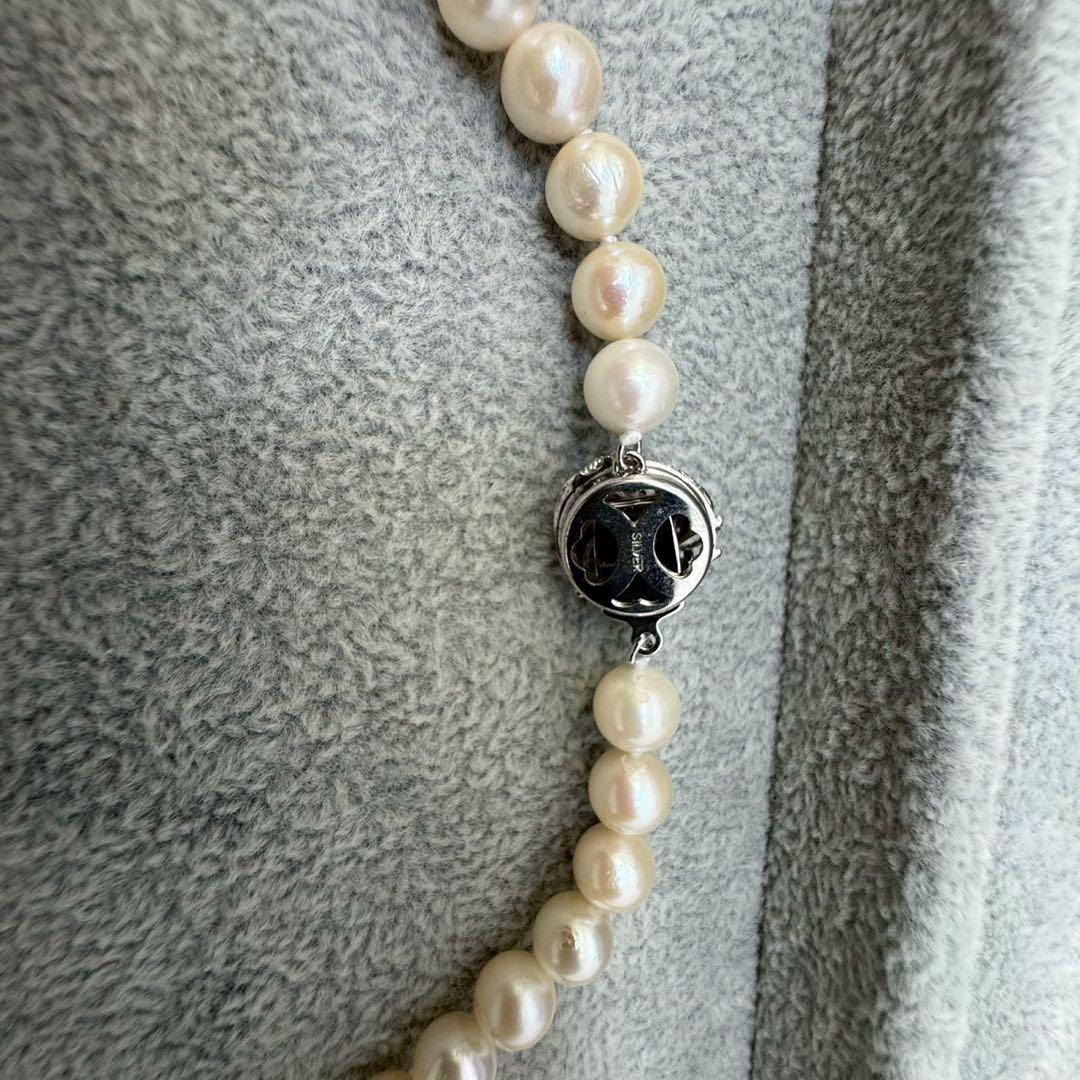 Short Akoya pearl necklace with 8mm white pearls on a white background